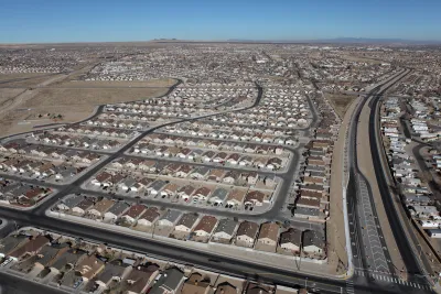 A spraling subdivision of single-family detached housing in a desert setting.