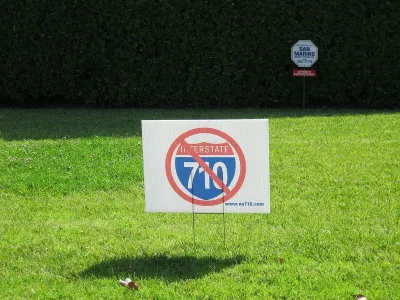 "No 710" lawn sign on green lawn.