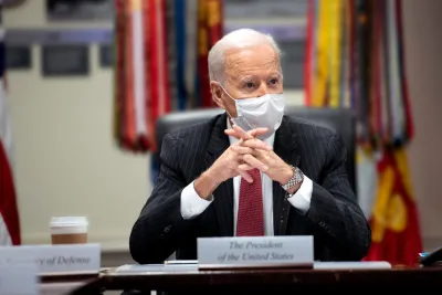 An image of President Joe Biden at a meeting in the White House while wearing a mask in February 2021.