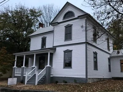 Restored white two-story historic home with black trim in Roanoke, Virginia