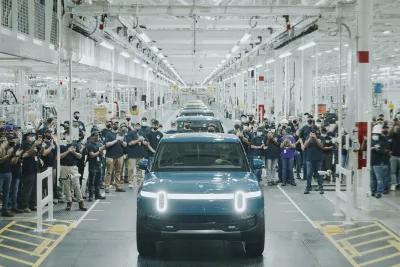 The first R1T built for a customer rolling off Rivian's assembly line at their plant in Normal, IL