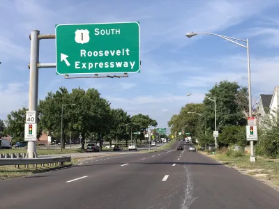 View of three-lane Roosevelt Boulevard with green Roosevelt Expressway road sign in Philadelphia, Pennsylvania.