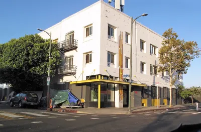 White three-story brick single-room occupancy hotel in downtown Los Angeles, California.