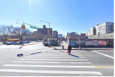 Google street view of New York City intersection with construction fence