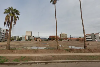 Google street view of vacant lot in Phoenix, Arizona with palm trees in foreground