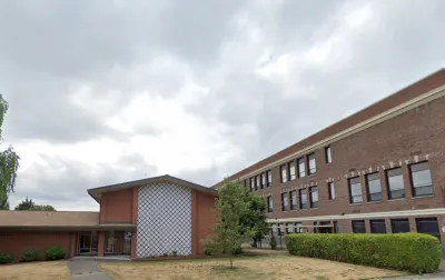 Google street view of red brick Catholic church in Seattle, Washington.