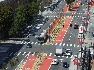 Aerial view of red center bus rapid transit lane with bus on Van Ness Avenue in San Francisco, California