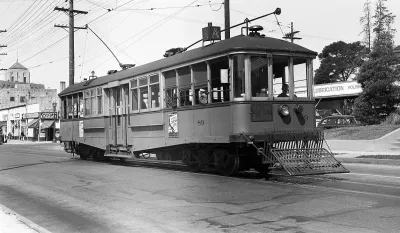 Black and white photo of a streetcar from the 1900s.