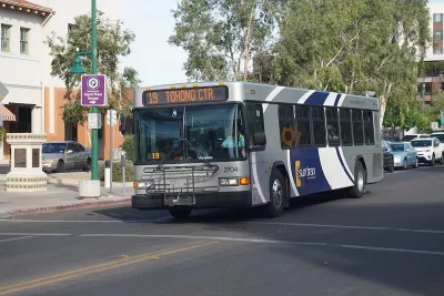 Silver and blue Sun Tran public transit bus on street in Tucson, Arizona.