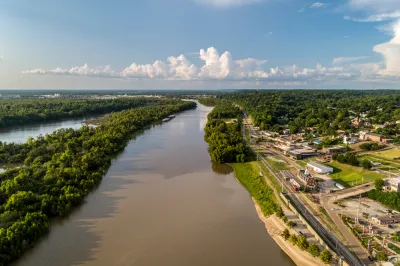 A diversion canal from the Yazoo River is shown from above. The river's banks are lined with industrial land uses near the city of Vicksburg, Mississippi.