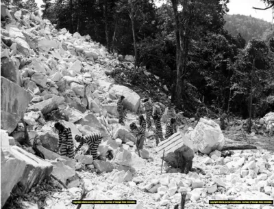Incarcerated people work in a rock quarry, possibly Keith Quarry near Palmetto, Georgia, around 1948.
