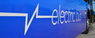 Close-up of white "electric bus" logo on side of blue Chicago public transit bus