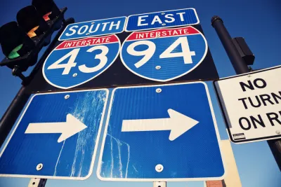 Closeup of blue I-94 and I-43 signs with arrows