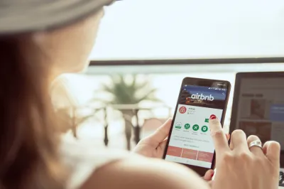 Woman searchinig Airbnb app on phone