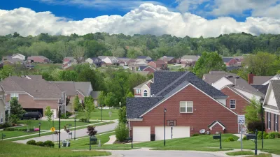 A Community of Brick Suburban Homes on a cloudy summer day