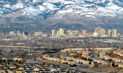 Aerial view of Reno, Nevada against snow-capped mountains in winter