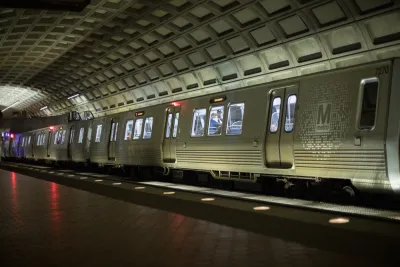 Silver DC Metro train in underground station with high arched ceiling