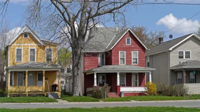 Old houses with large porch and colorful siding