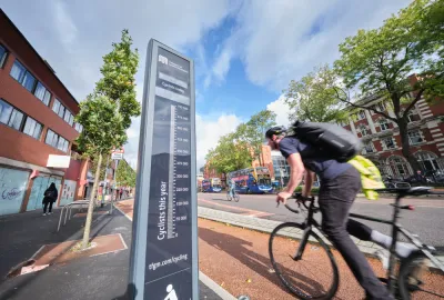 Black bike counter with cyclists passing by on Manchester, UK bike path