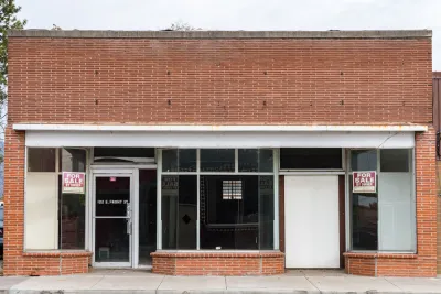 Line of vacant small storefronts with For Sale signs in Merrill, Oregon