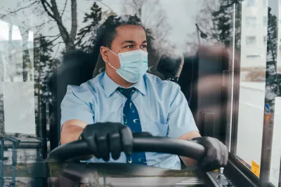 Bus driver wearing a COVID-19 protective mask