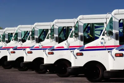 A row of USPS delivery trucks