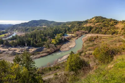 Aerial view of Eel River running through California forest