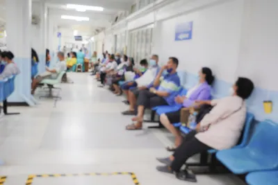 Blur image of patients in a hospital waiting area.