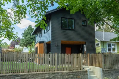Dark grey two-story accessory dwelling unit in backyard