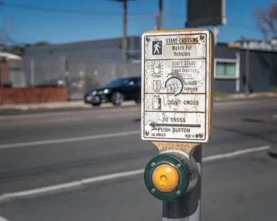 Close-up of pedestrian crossing button at a crosswalk in Los Angeles