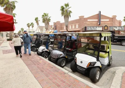 Line of golf carts parked on street in The Villages, Florida