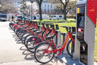 Station with rown of red Capital Bikeshare parked bikes on Washington, D.C. sidewalk