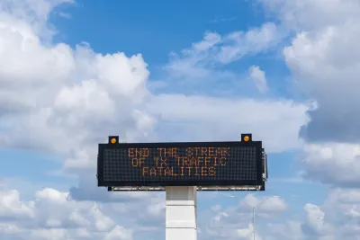 Highway sign with "Stop the strak of TX traffic fatalities" against blue sky