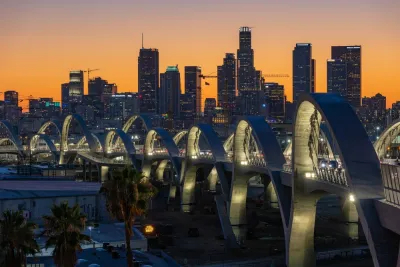 6th Street Viaduct against the Los Angeles skyline at dusk
