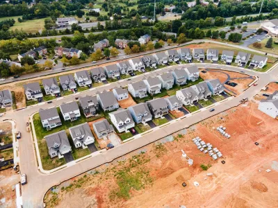 Aerial view of dense single-family homes in neighborhood still under construction