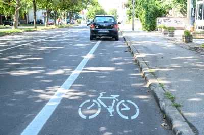 Black car parked in bike lane