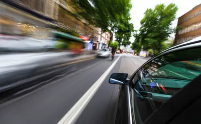 Blurry speeding cars on an urban road