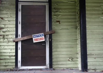 Vacant home with foreclosure sign.