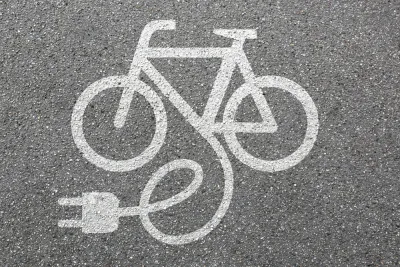 White electric bike logo on asphalt