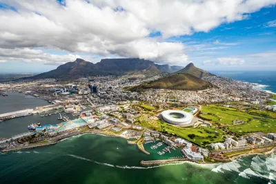 Aerial view of Cape Town, South Africa with development on coast and mountains in background