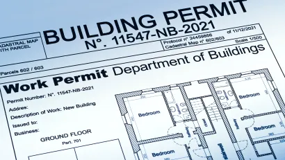 View of a housing permit document with a home blueprint, stamped "approved."