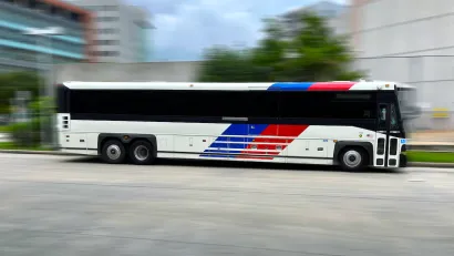 Houston Metro bus moving rapidly across blurred background.
