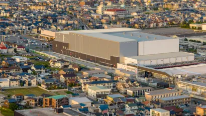 Aerial view of large warehouse in neighborhood.