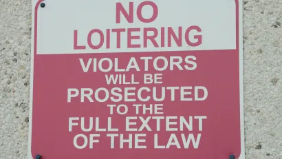 Red and white "No Loitering" sign.
