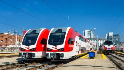 Two red and white electric trains, part of Caltrain fleet in San Francisco, California.