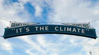 "It's The Climate" sign over street in Grants Pass, Oregon.