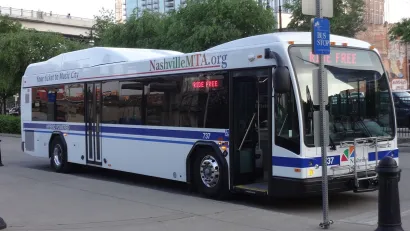Nashville MTA transit bus at station on street.