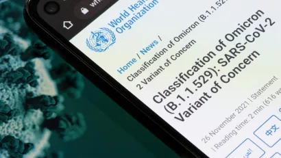 An image showing a smart phone with information from the World Health Organization about the Omicron variant of the coronavirus.