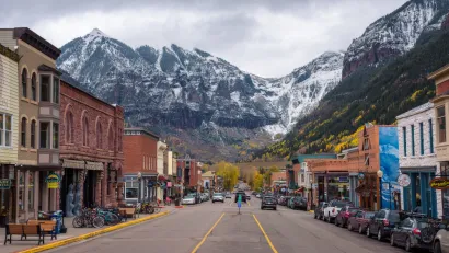 View from middle of street in downtown Telluride, Colorado with mountains in background