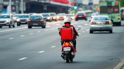 Back view of delivery scooter on roadway